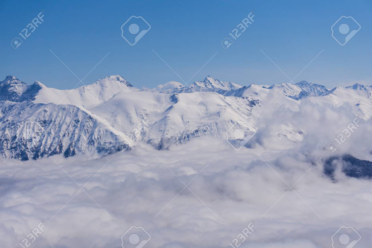 Amazing view of snowy mountains from above the clouds movie